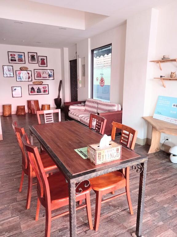 a dining room with a table and chairs at Mixa Hostel in Hualien City