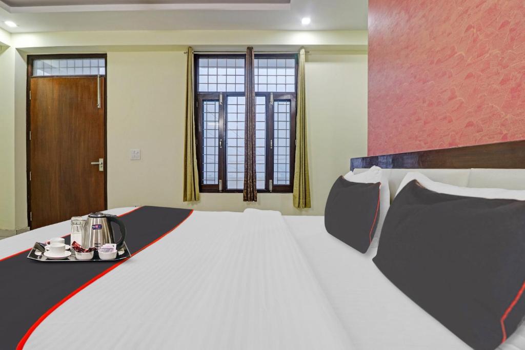 a room with a large bed in a room at Collection O Hotel Premnagar Heights in Dehradun