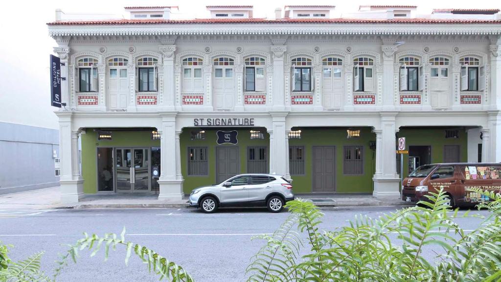 a car parked in front of a building at ST Signature Jalan Besar in Singapore