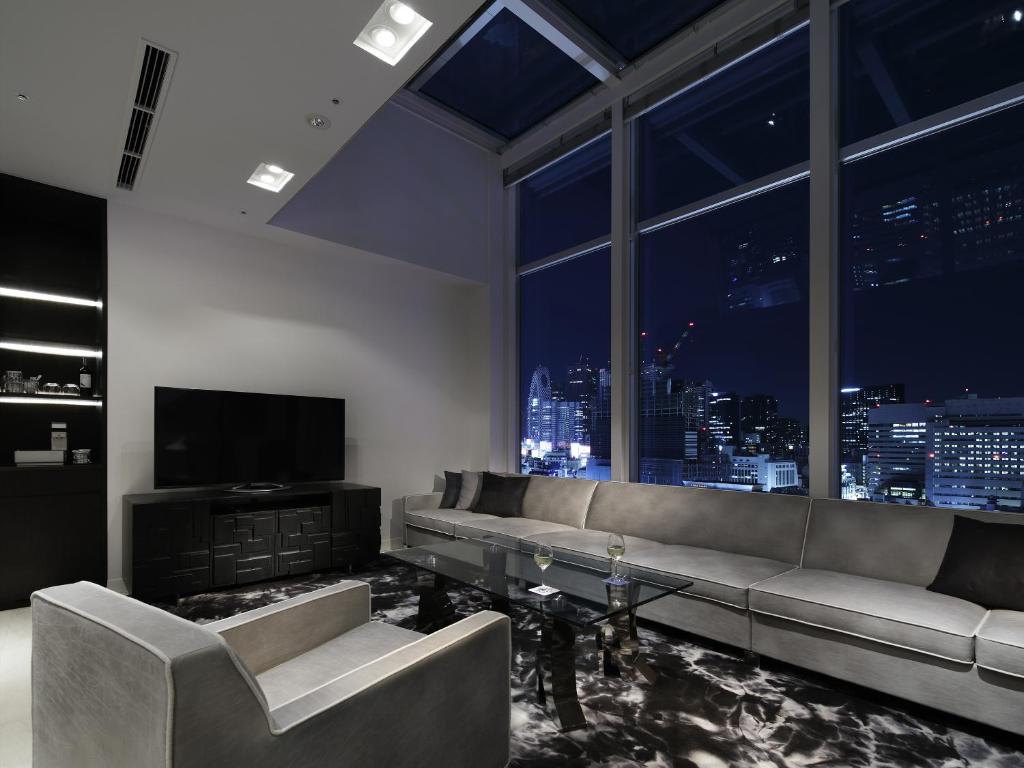 a living room with a couch and a television at Shinjuku Granbell Hotel in Tokyo