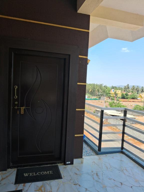 a black door on a building with a view at Royal homes a4 in Kushālnagar