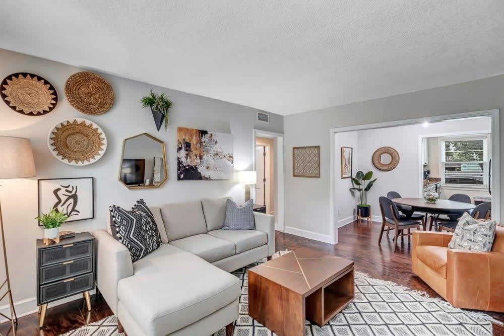 a living room with a couch and a table at Modern 2 BR Condo - 2 block from San Marco in Jacksonville