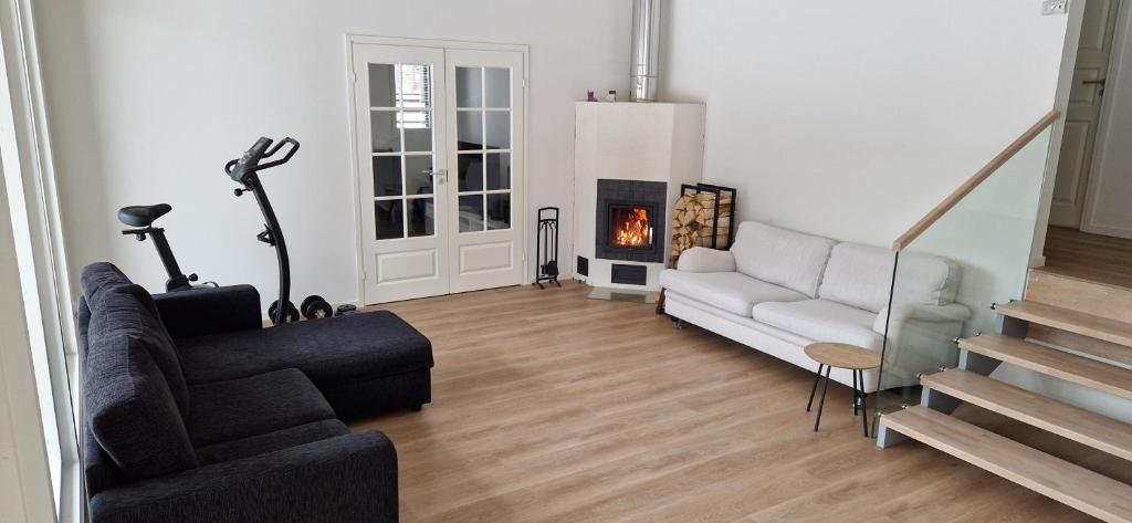 a living room with a couch and a fireplace at Uusi omakotitalo nyt saatavilla! in Kerava