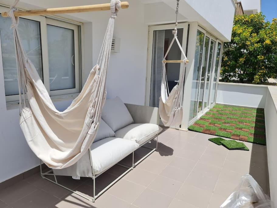 a porch with a hammock on a house at Almaza Bay Beachtown Ground Chalet in Marsa Matruh