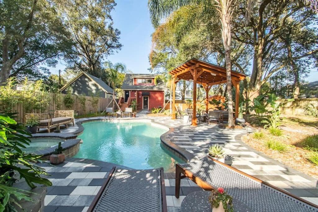 a swimming pool in a backyard with a gazebo at Unique studio w pool spa & gardens near downtown in Jacksonville