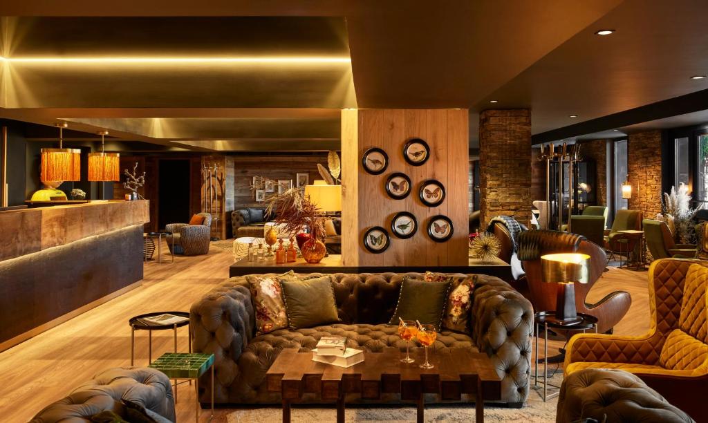 a living room with a couch and chairs at Hôtel L'Arboisie in Megève