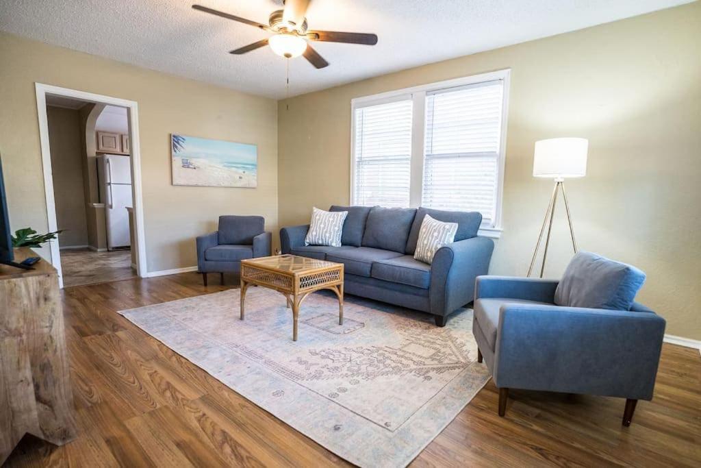 a living room with a blue couch and a table at Charming Riverside Retreat 1 1 - Near 5 Points #2 in Jacksonville