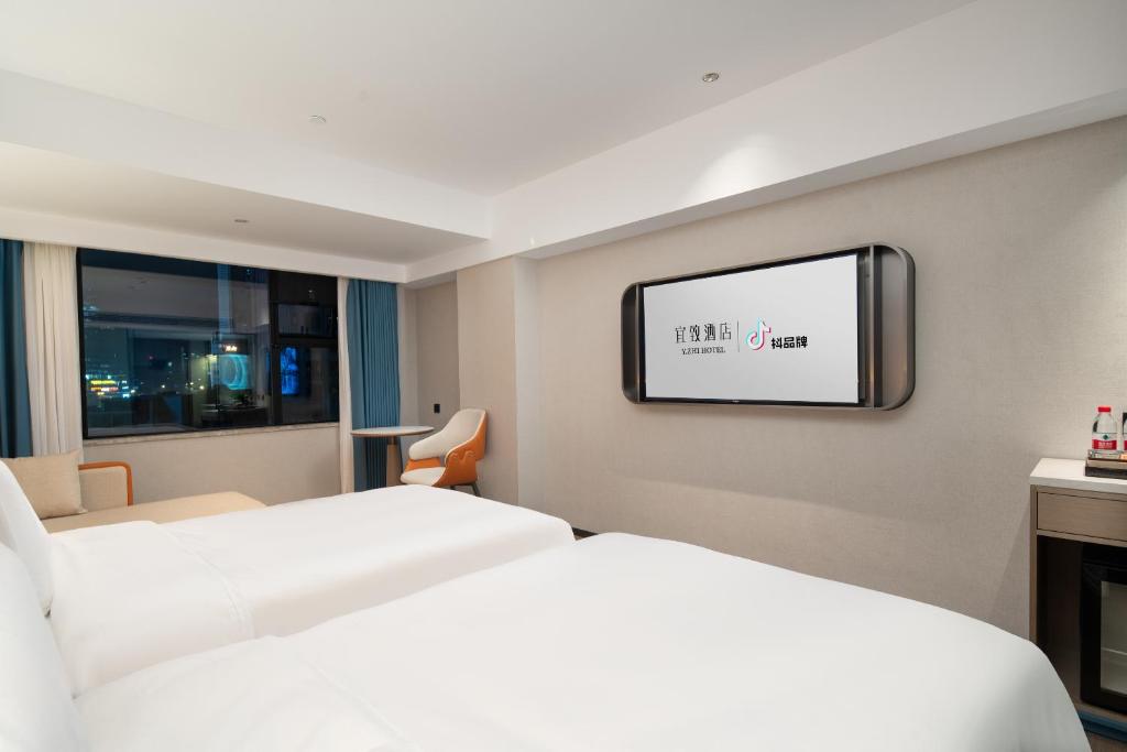 Postel nebo postele na pokoji v ubytování Yizhi Hotel Changgang Metro Station - Free Shuttle Bus during Canton Fair