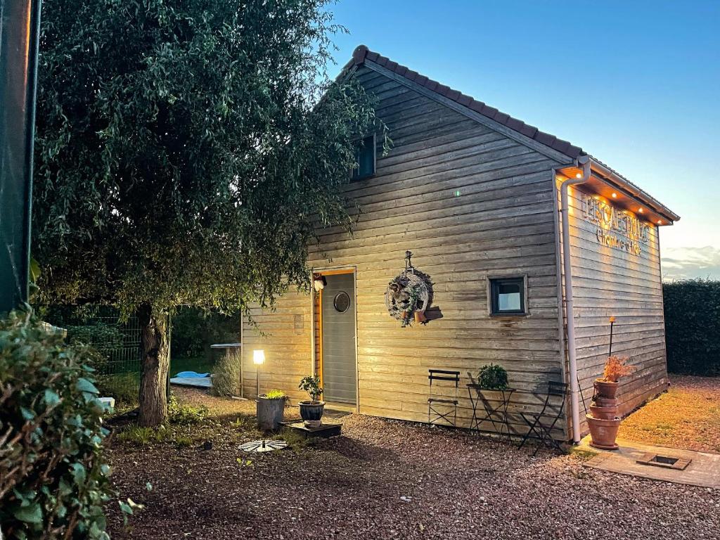 a small shed with lights on the side of it at L’Escale du lac in Brêmes