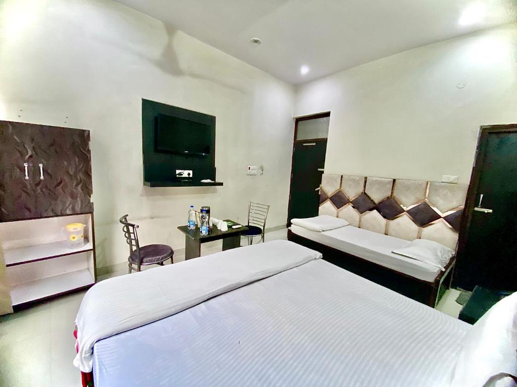 A bed or beds in a room at swaran House
