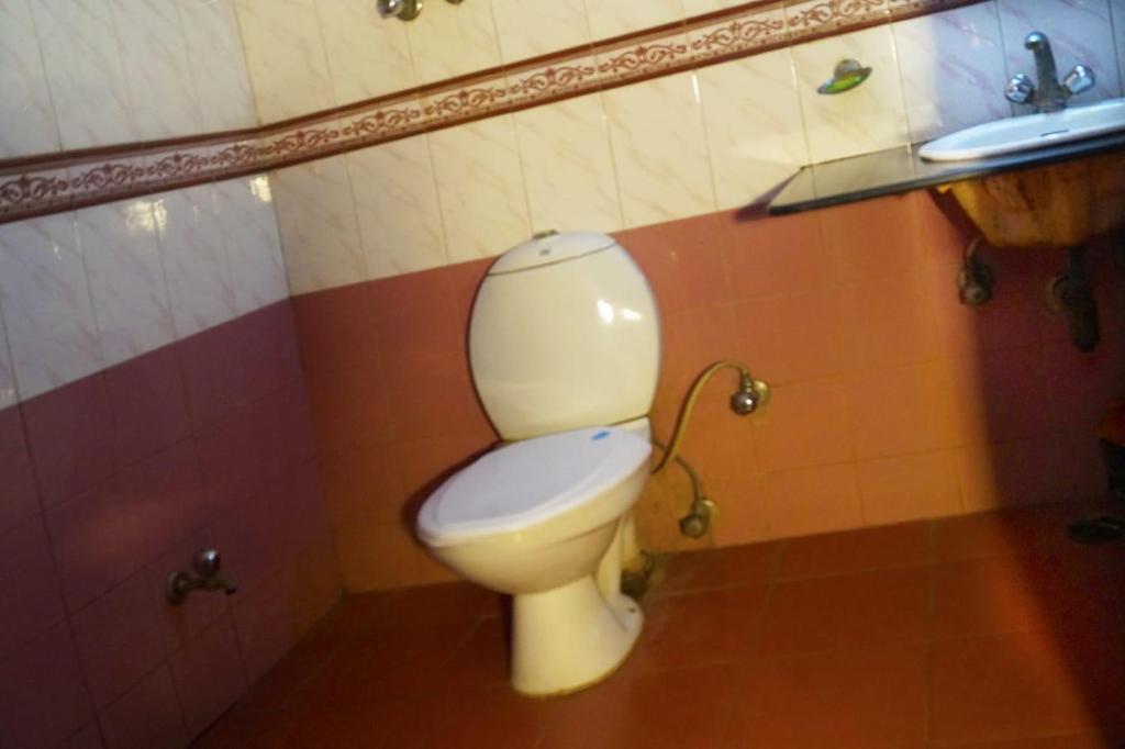 a bathroom with a toilet and a sink at Hotel HRS - New Delhi Railway Station in New Delhi