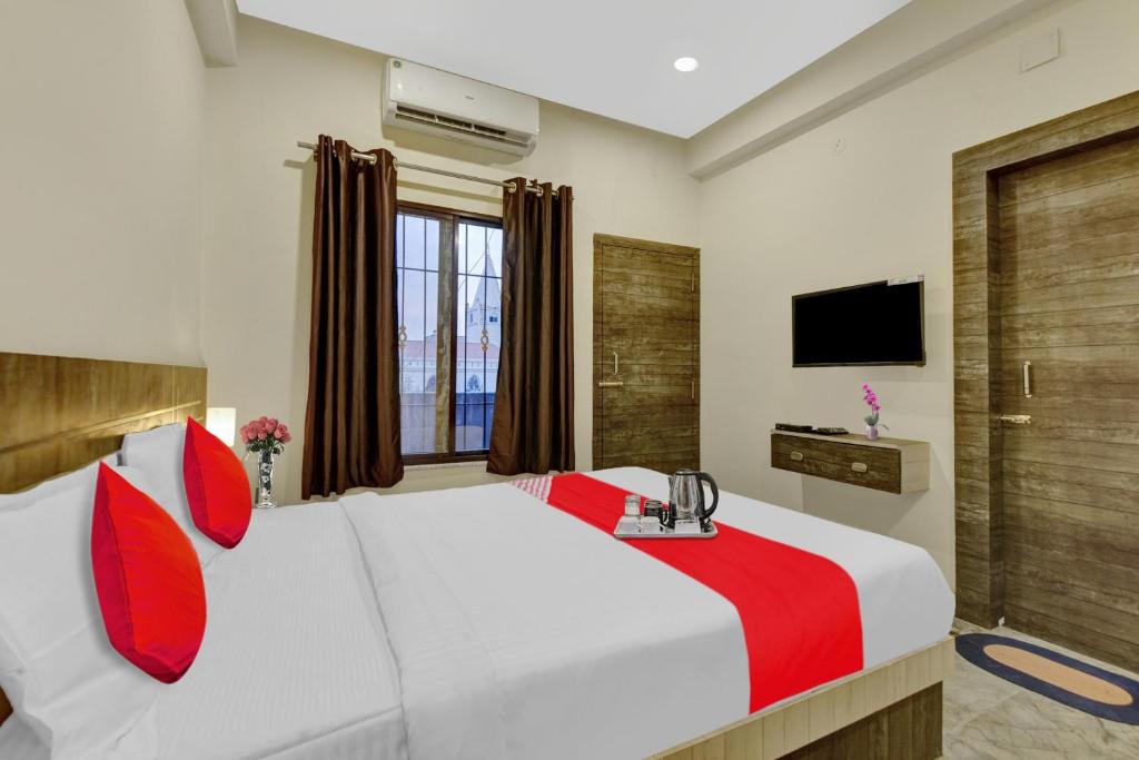 a bedroom with a large white bed with red pillows at Flagship Hotel Royals in Rānchī
