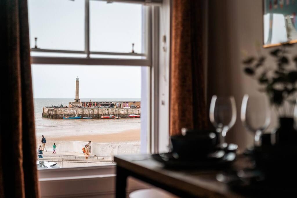 a view of the beach from a room with a window at Margate Bliss 3Bed House Steps Away from the Beach in Margate