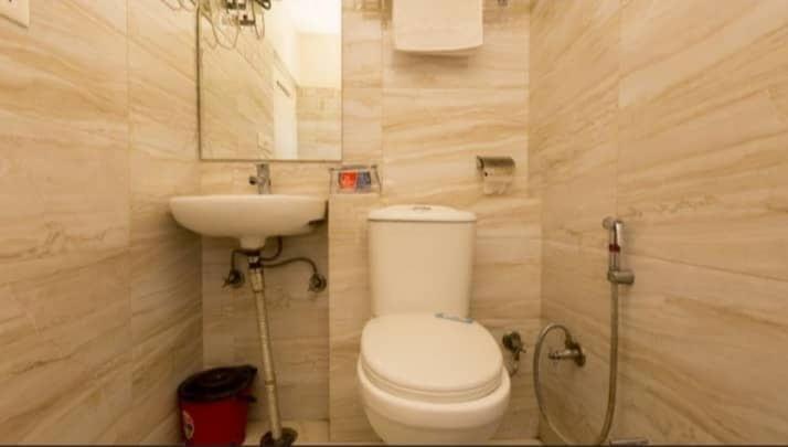 a bathroom with a white toilet and a sink at Hotel HRS - New Delhi Railway Station in New Delhi