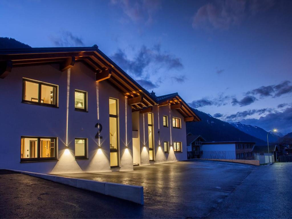 een huis met lichten aan de zijkant 's nachts bij Chalet Montafon in Gaschurn with Sauna in Gaschurn