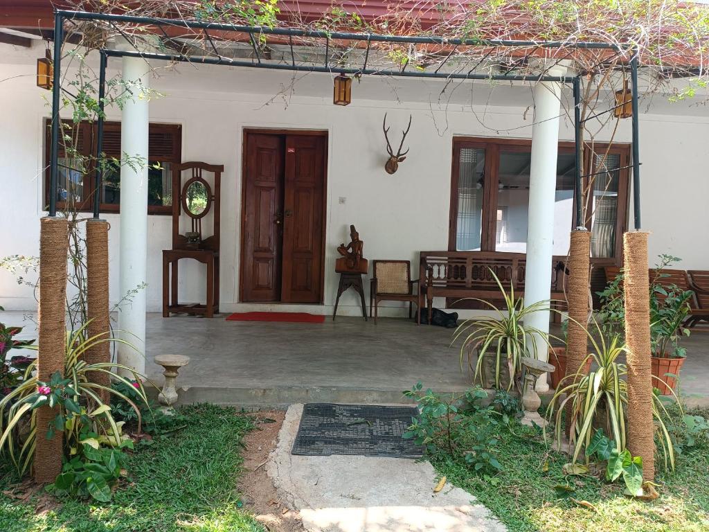 a front porch of a white house with at Richland's Villa in Kandy