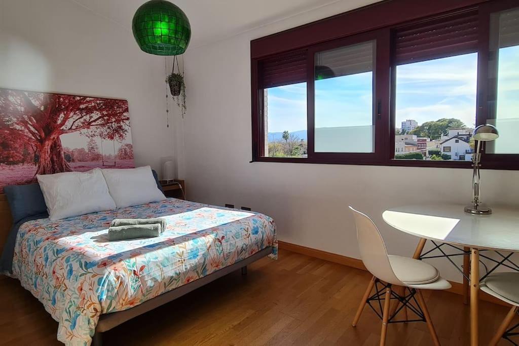 a bedroom with a bed and a table and chairs at Ático familiar con todas las comodidades. in Murcia