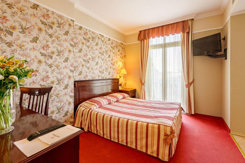 Postel nebo postele na pokoji v ubytování Boutique Splendid Hotel