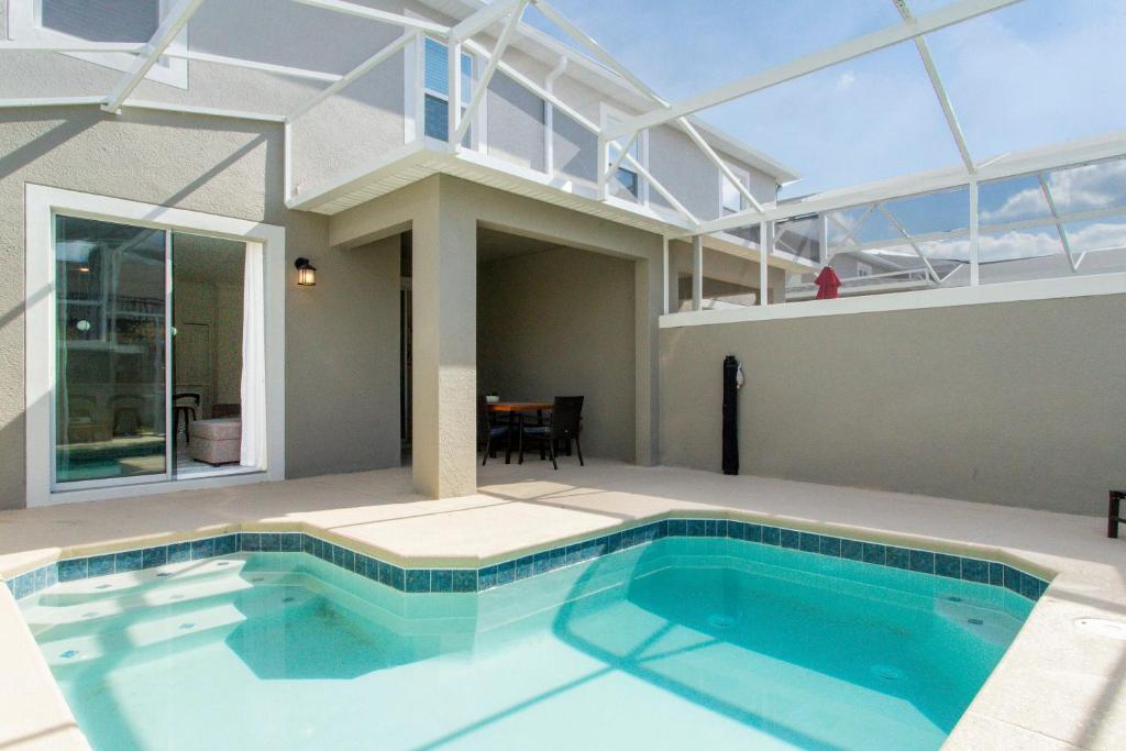 a large swimming pool in a house with a roof at 1056 LS - Luxury 4BR3BA - Champions Gate Bliss in Kissimmee