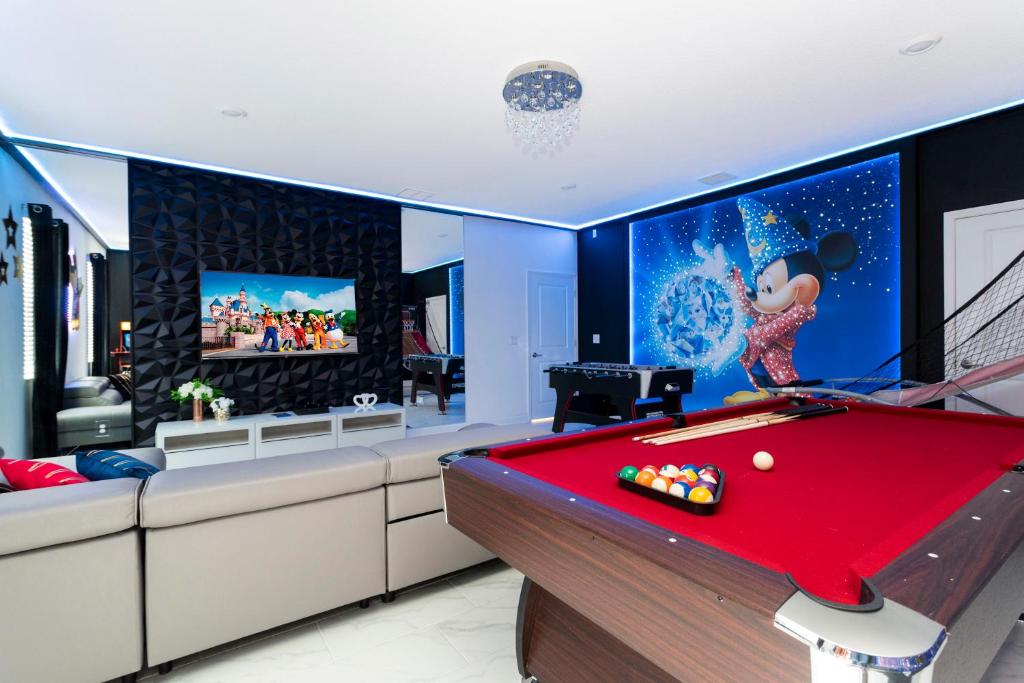 a room with a pool table and a tv at 9312 SH - Champions Gate - Unique High end 8 Beds in Davenport