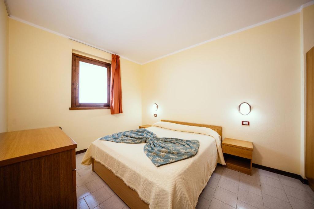 Postel nebo postele na pokoji v ubytování Hotel Residence Campi