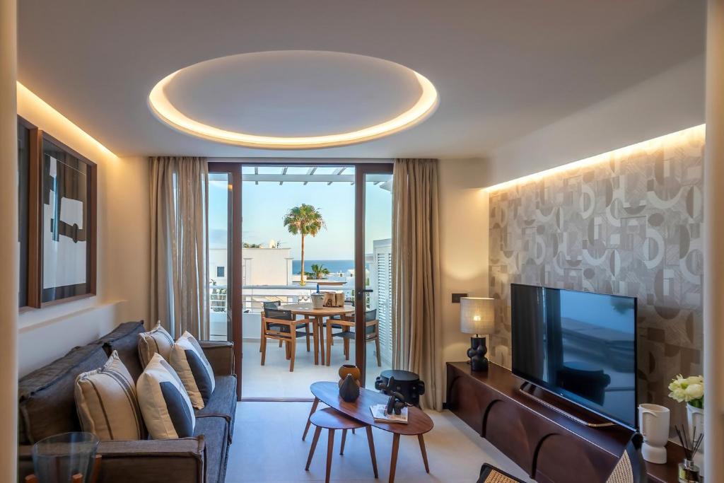 a living room with a couch and a tv at PRB Aparment Puerto del Carmen in Puerto del Carmen