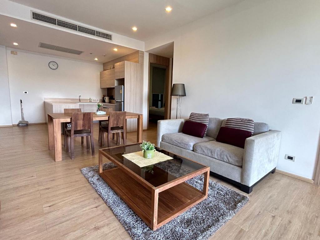 un soggiorno con divano e tavolo di 2 Bedroom Beachfront Apartment With Sea Views a Mai Khao Beach