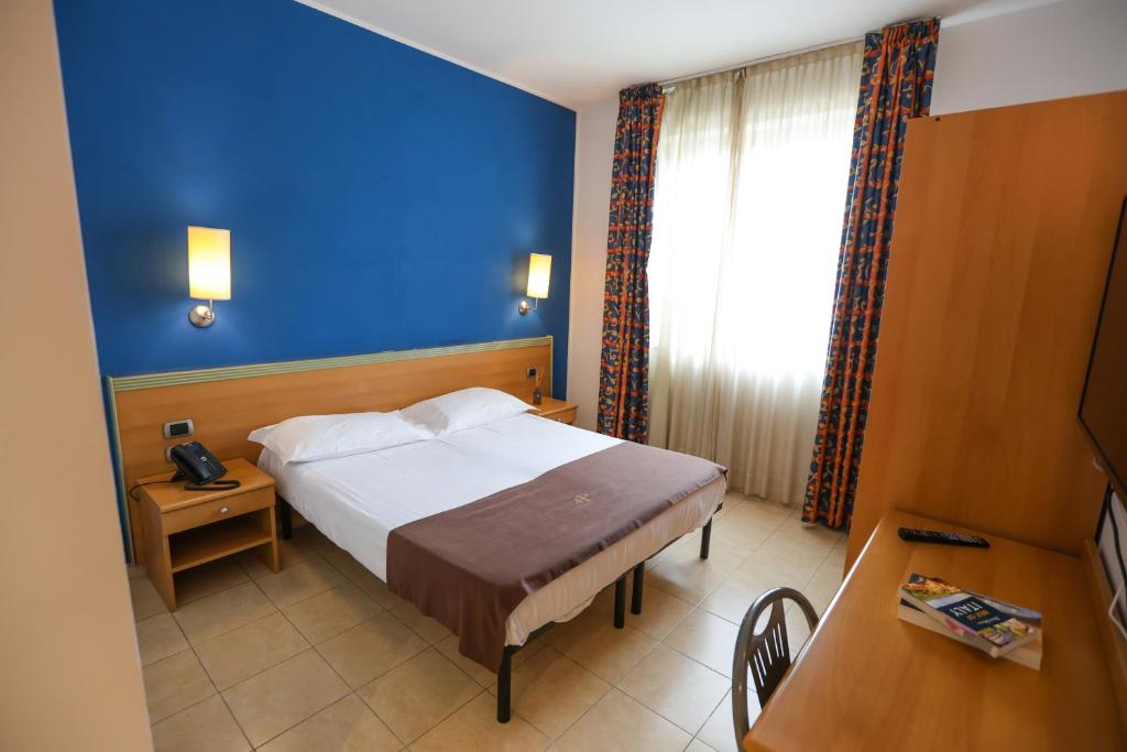 Łóżko lub łóżka w pokoju w obiekcie Palace Hotel Due Ponti