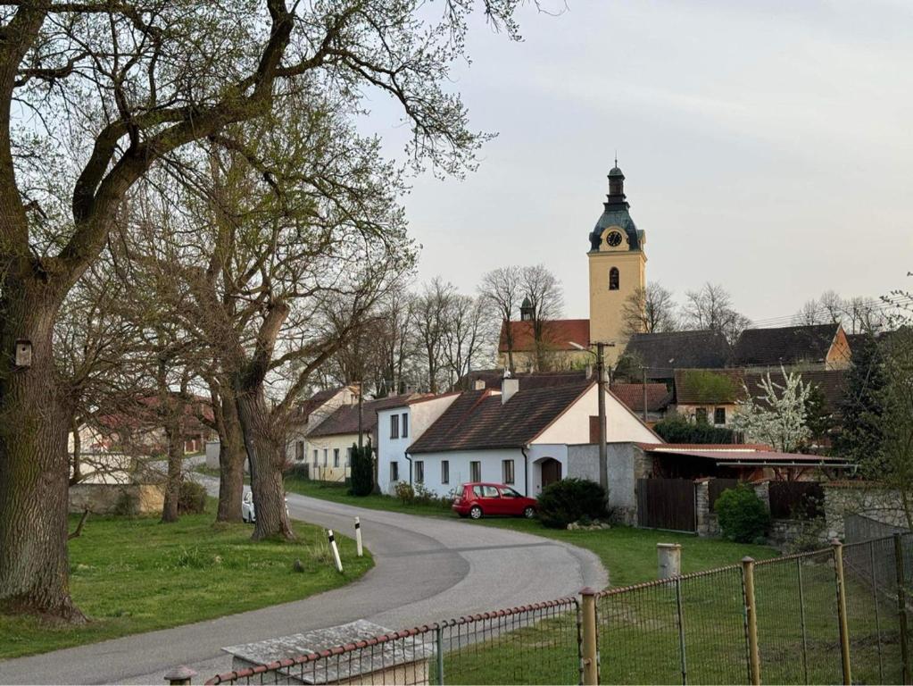 a small village with a church and a road at Apartmán Putim in Písek