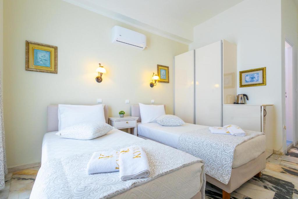 Postel nebo postele na pokoji v ubytování Kymata Hotel