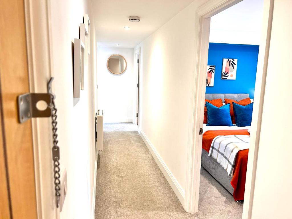 a hallway leading to a bedroom with a bed at Sea views - Harbour view, Torquay Central location in Torquay