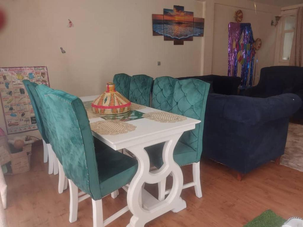 a table and chairs in a living room at Cozy Private Room at a Homestay with Facilities in Addis Ababa