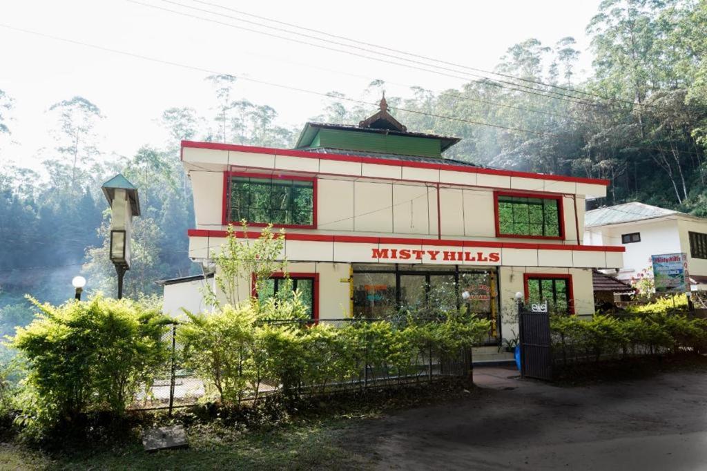 a building with a misify hills sign on it at Misty Hills Munnar in Munnar