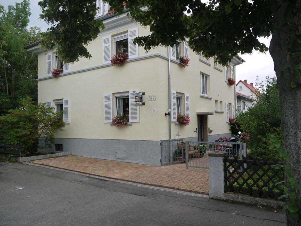 a white house with flowers on the windows at Neckar-Koje in Neckarsulm