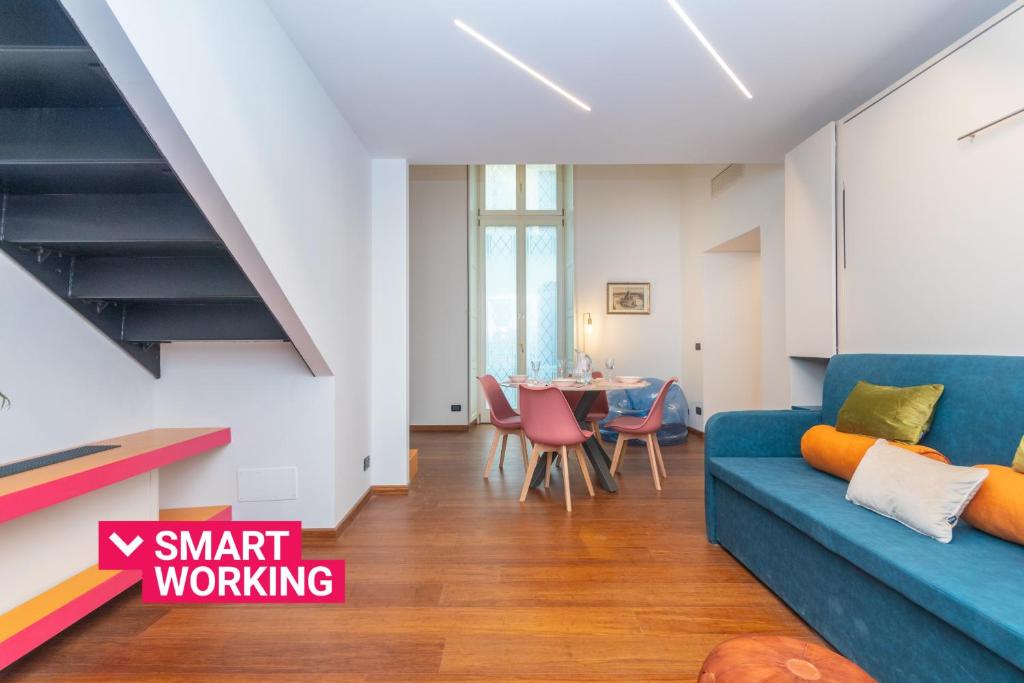 a living room with a blue couch and a table at Elegant Home with Sauna in Turin by Wonderful Italy in Turin