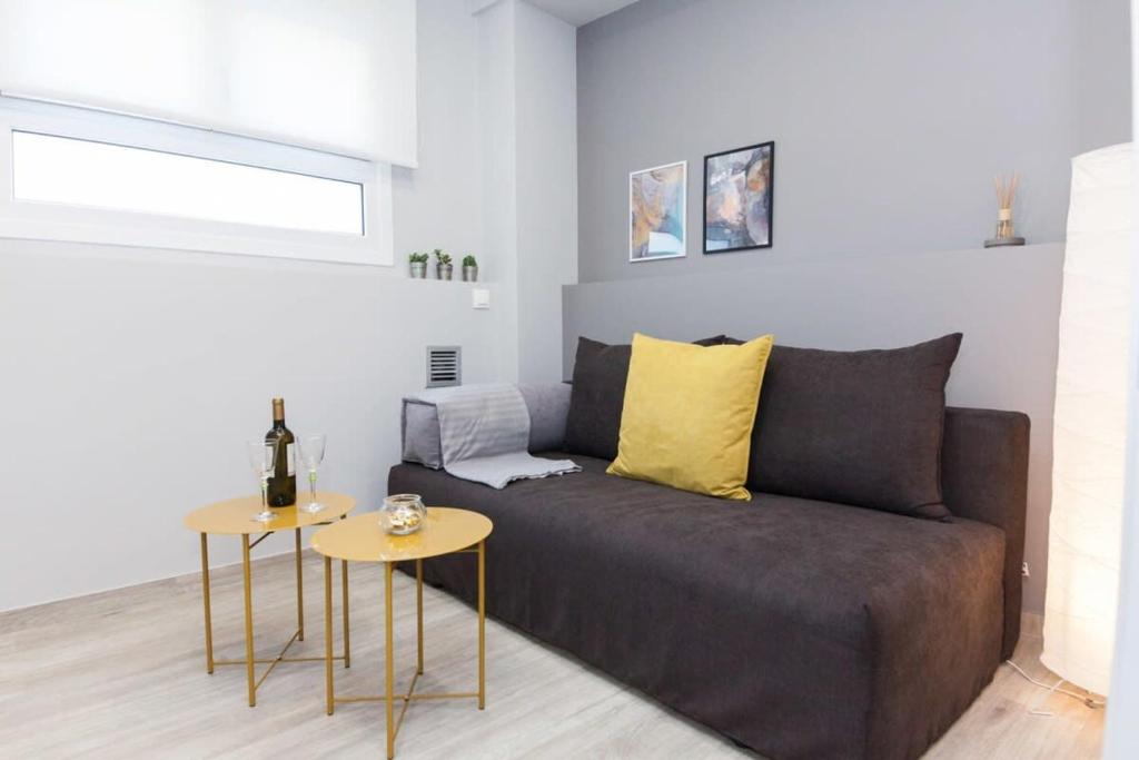 a living room with a couch and a table at Brand New flat near Lycabettus Hill by Luckeys in Athens