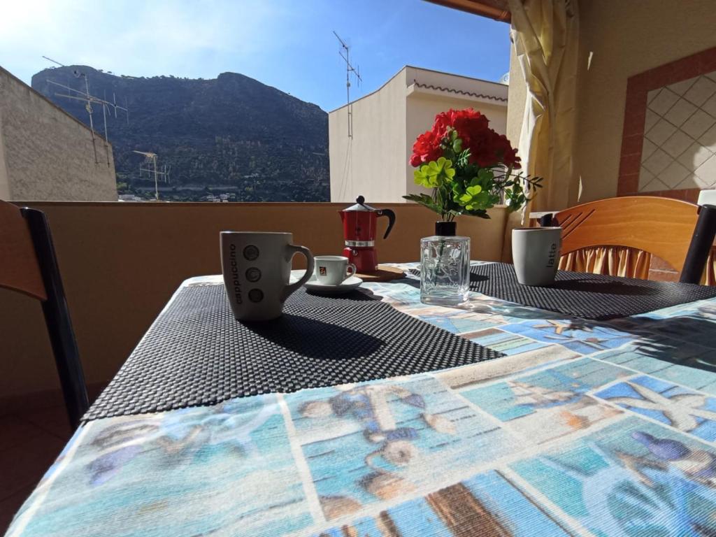 a table with two mugs on it with a view at Sandro Apartment in Castellammare del Golfo