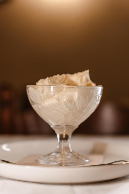 a glass bowl of ice cream on a plate at Tamahuche Hotel Rural in Vallehermoso