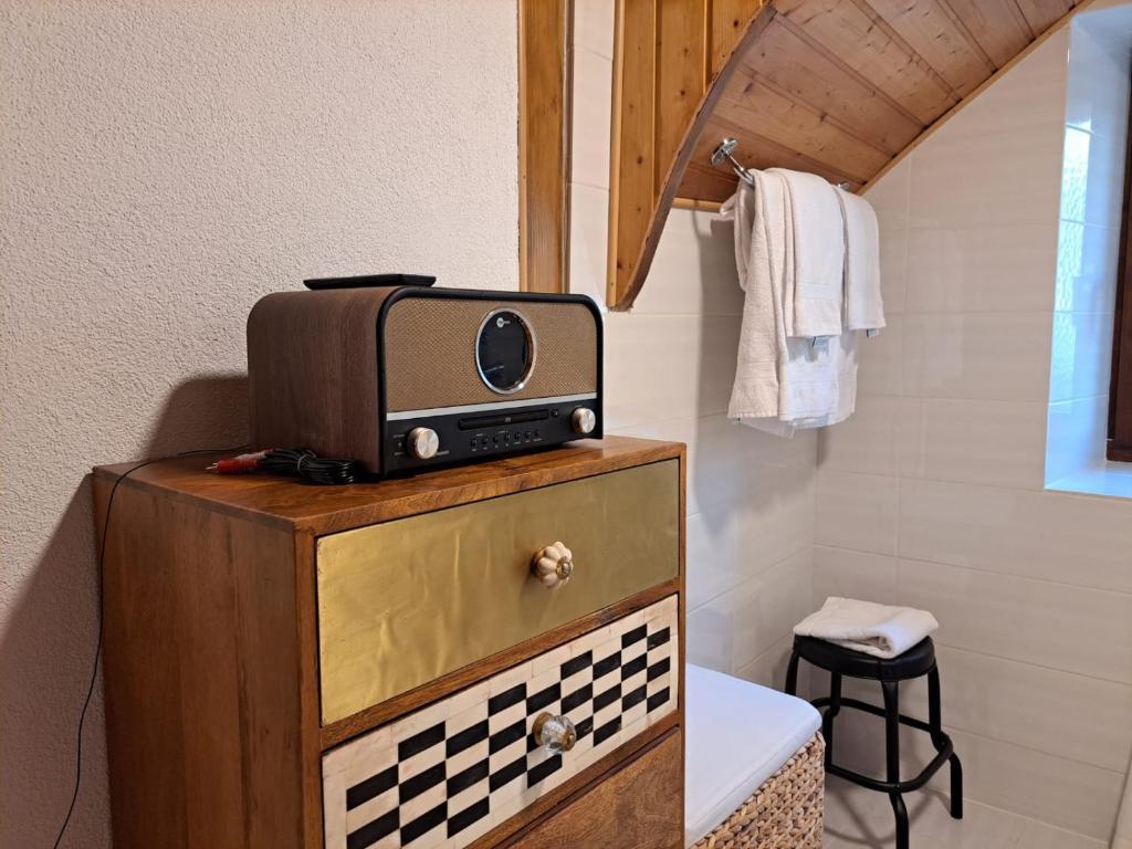 a microwave on top of a dresser in a bathroom at Casa Gianna by Quokka 360 - Romantic next to Bellinzona hospital in Bellinzona