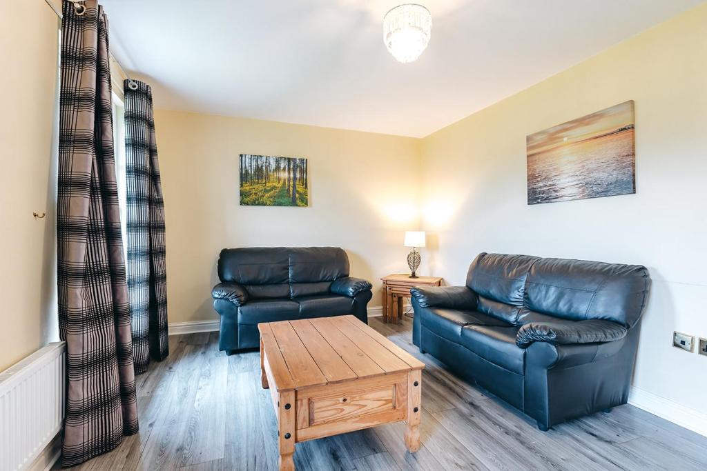 a living room with two leather couches and a coffee table at Finest Retreats - Netley Hall - Lavender in Dorrington