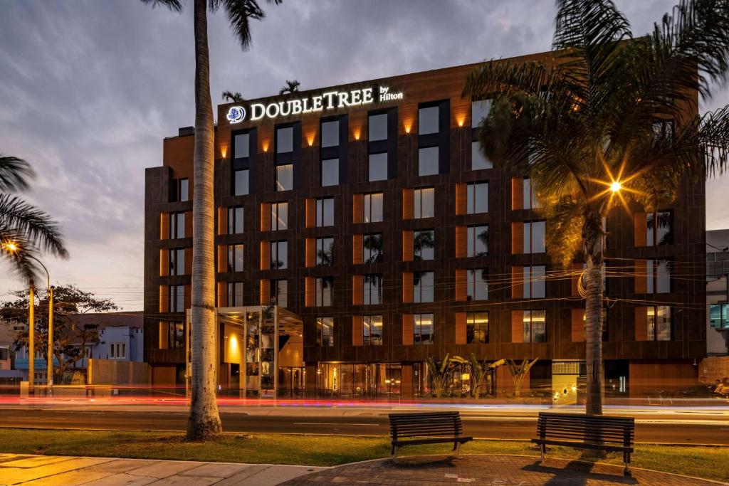 a building with a street sign in front of it at Doubletree By Hilton Lima San Isidro in Lima