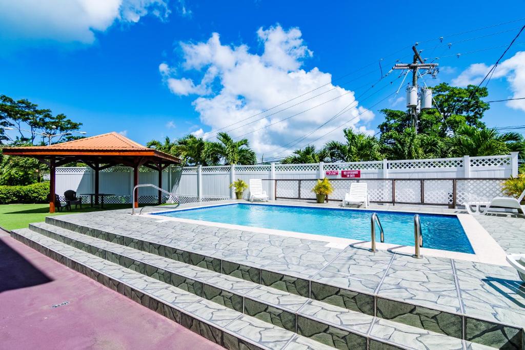 a swimming pool in a yard with a gazebo at Compass Apartments in True Blue