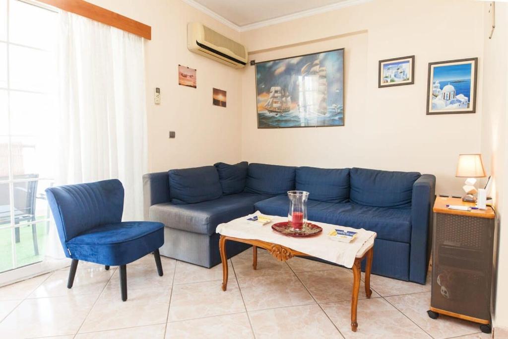 un soggiorno con divano blu e tavolo di Cute one bedroom apartment in Pireas a Pireo
