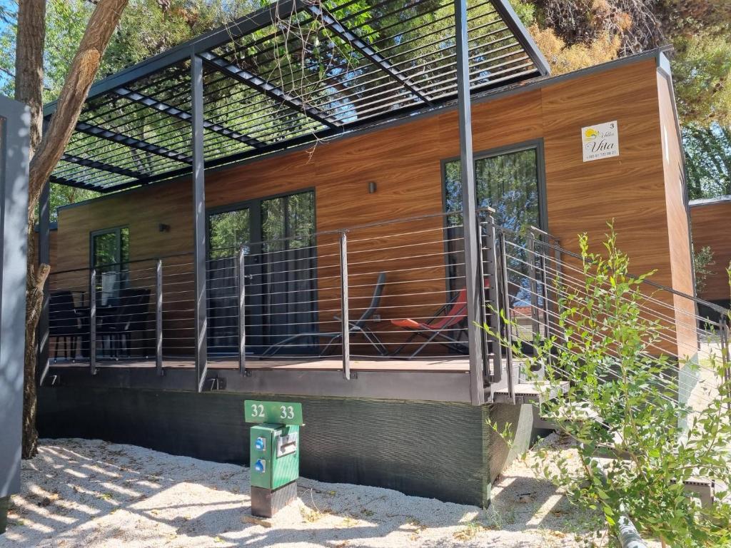 a building with a staircase leading up to it at mobilne kuće Villa Vita in Vodice