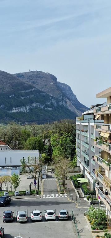 ein Parkplatz mit Autos vor einem Gebäude in der Unterkunft Chambre double privée, Appartement partagé in Annemasse