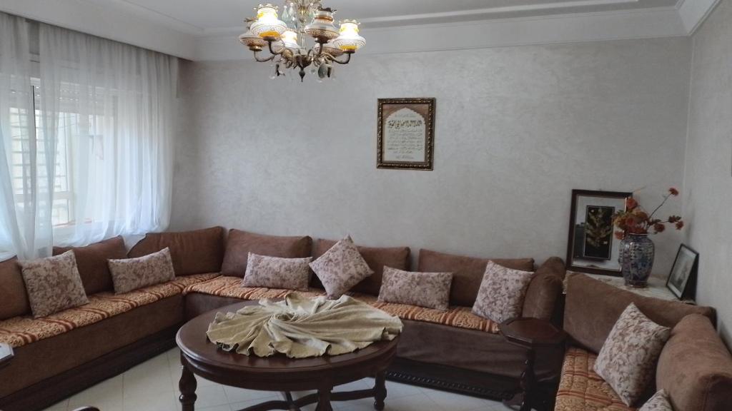 a living room with a couch and a table at tranquil harmony in Casablanca