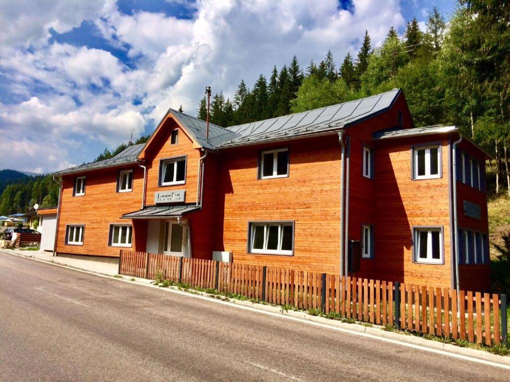 a wooden house on the side of a road at Apartmán Horalka 7 v Peci pod Sněžkou in Pec pod Sněžkou