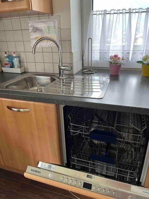 a kitchen with a sink and a dish washer at Large 8 Bed Apartment. Perfect Location. in Stuhlfelden