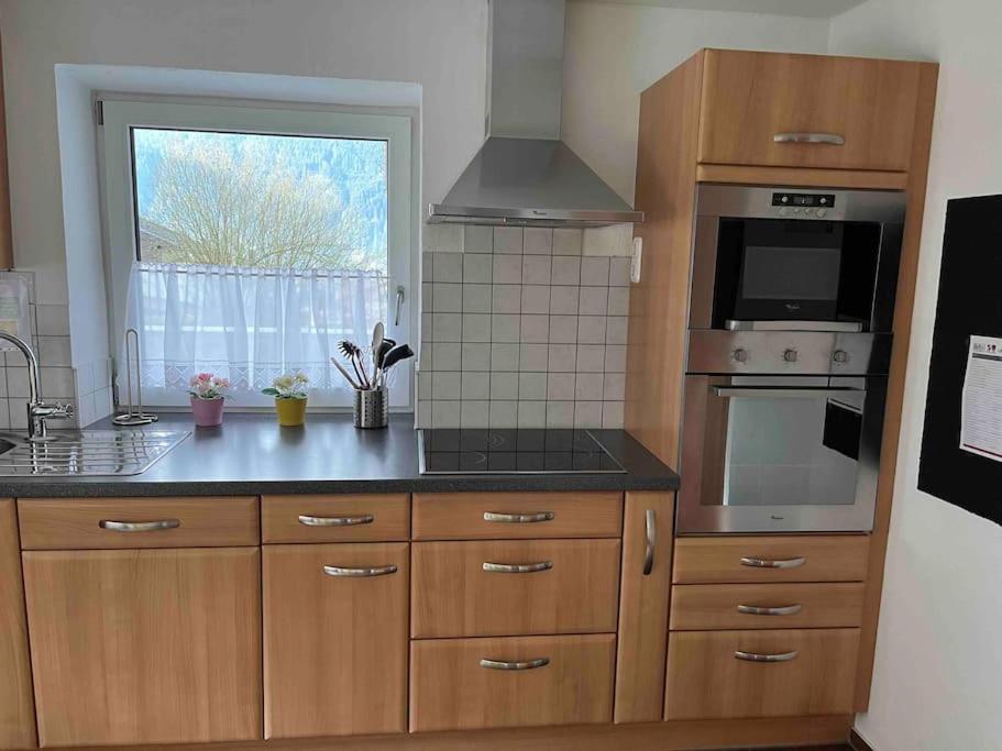 a kitchen with wooden cabinets and a stove top oven at Large 8 Bed Apartment. Perfect Location. in Stuhlfelden