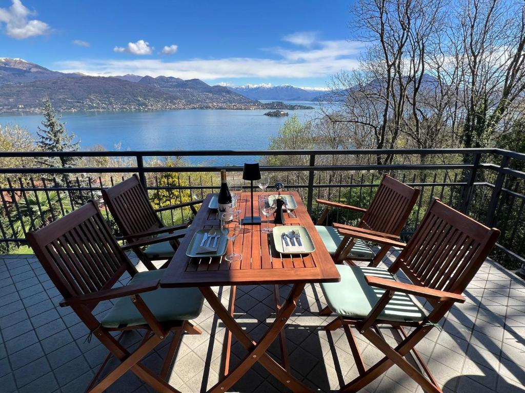 a table and chairs on a balcony with a view of a lake at Miralago in Stresa